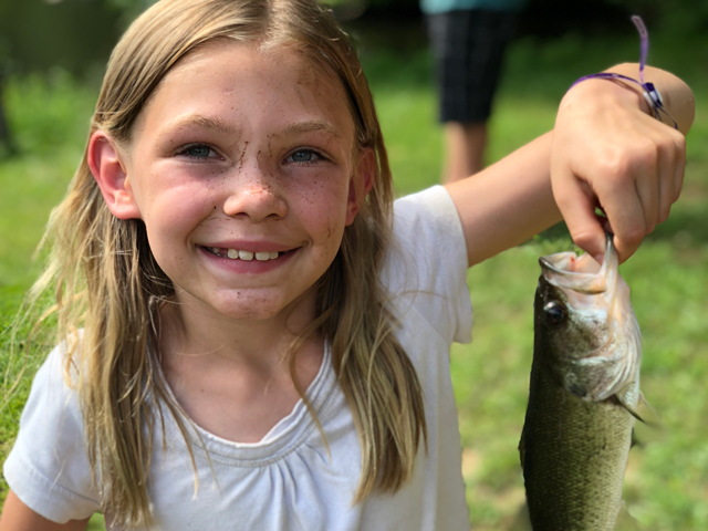 Great fishing opportunities in the lake. This child is holding up her catch.